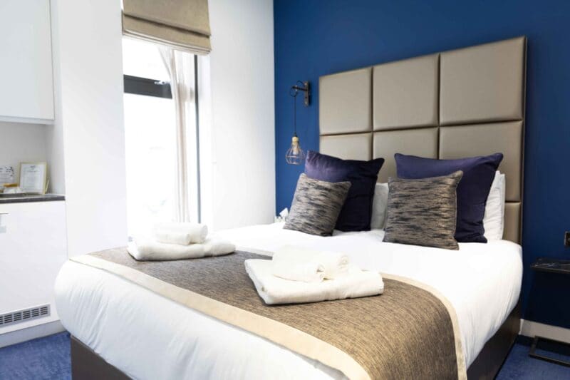 Luxury serviced apartments and rooms in Monument, London EC3R, highlighting the Harbinger bedroom at OSiT 20 St Dunstan's Hill.