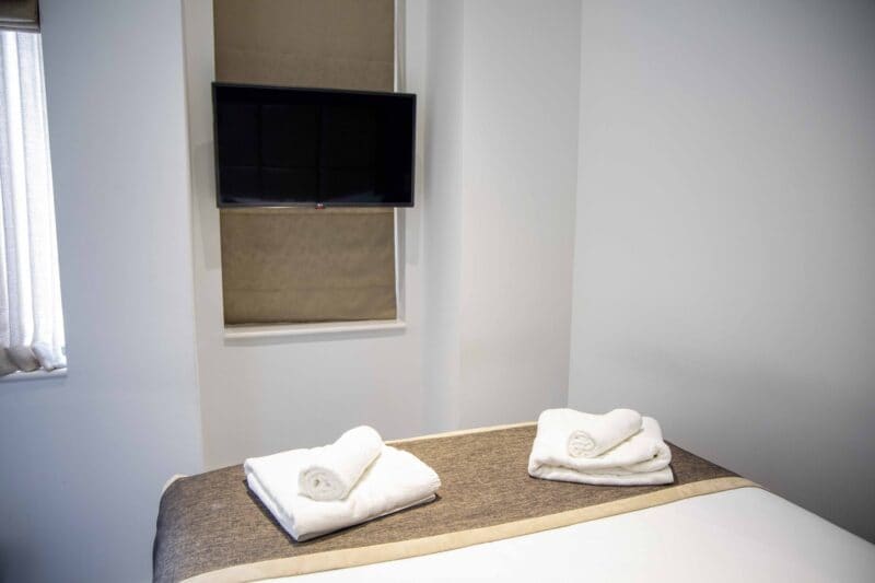 Luxury serviced accommodation amenities in Monument London EC3R, showcasing the boutique hotel standard features and nautical decor of the Harbinger room at OSiT 20 St Dunstan's Hill.