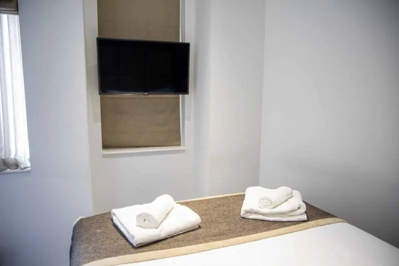 Luxury serviced accommodation amenities in Monument London EC3R, showcasing the boutique hotel standard features and nautical decor of the Harbinger room at OSiT 20 St Dunstan's Hill.