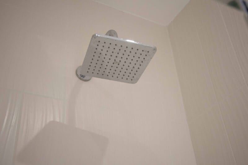 Premium guest facilities at The Cabins by Office Space in Town, highlighting the integrated technology, smart storage, and luxury soft furnishings provided in the Harbinger corporate bedroom.