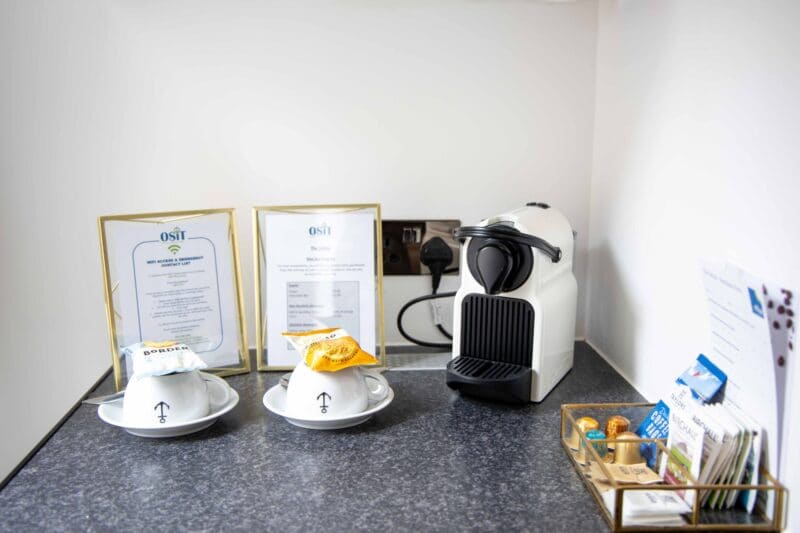 Luxury serviced accommodation amenities in Monument London EC3R, showcasing the boutique hotel standard features and nautical decor of the Harbinger room at OSiT 20 St Dunstan's Hill.