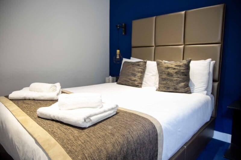 Luxury serviced bedrooms at OSiT Monument featuring the Hesperus room, a boutique hotel-style cabin with a Sunseeker yacht-inspired interior and high-end finishes in the City of London.
