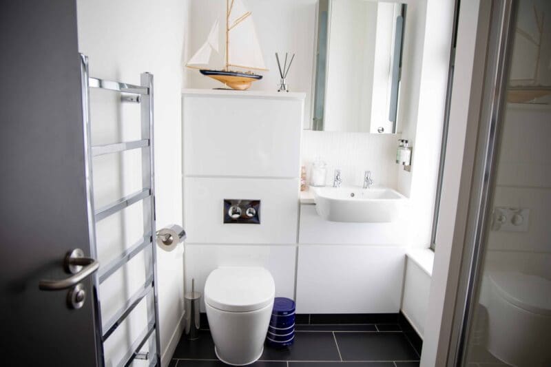 Premium amenities at The Cabins by Office Space in Town, showcasing the smart storage, plush linens, and integrated technology provided for business travelers staying in the Hesperus bedroom.