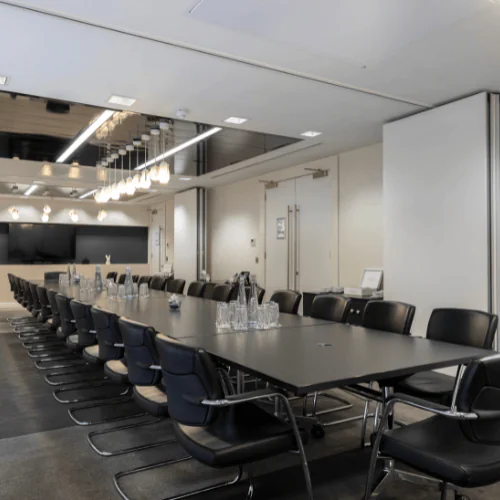 A high-spec professional meeting suite at Office Space in Town Waterloo, equipped with advanced AV technology and luxury boutique seating for creative business presentations near the South Bank.