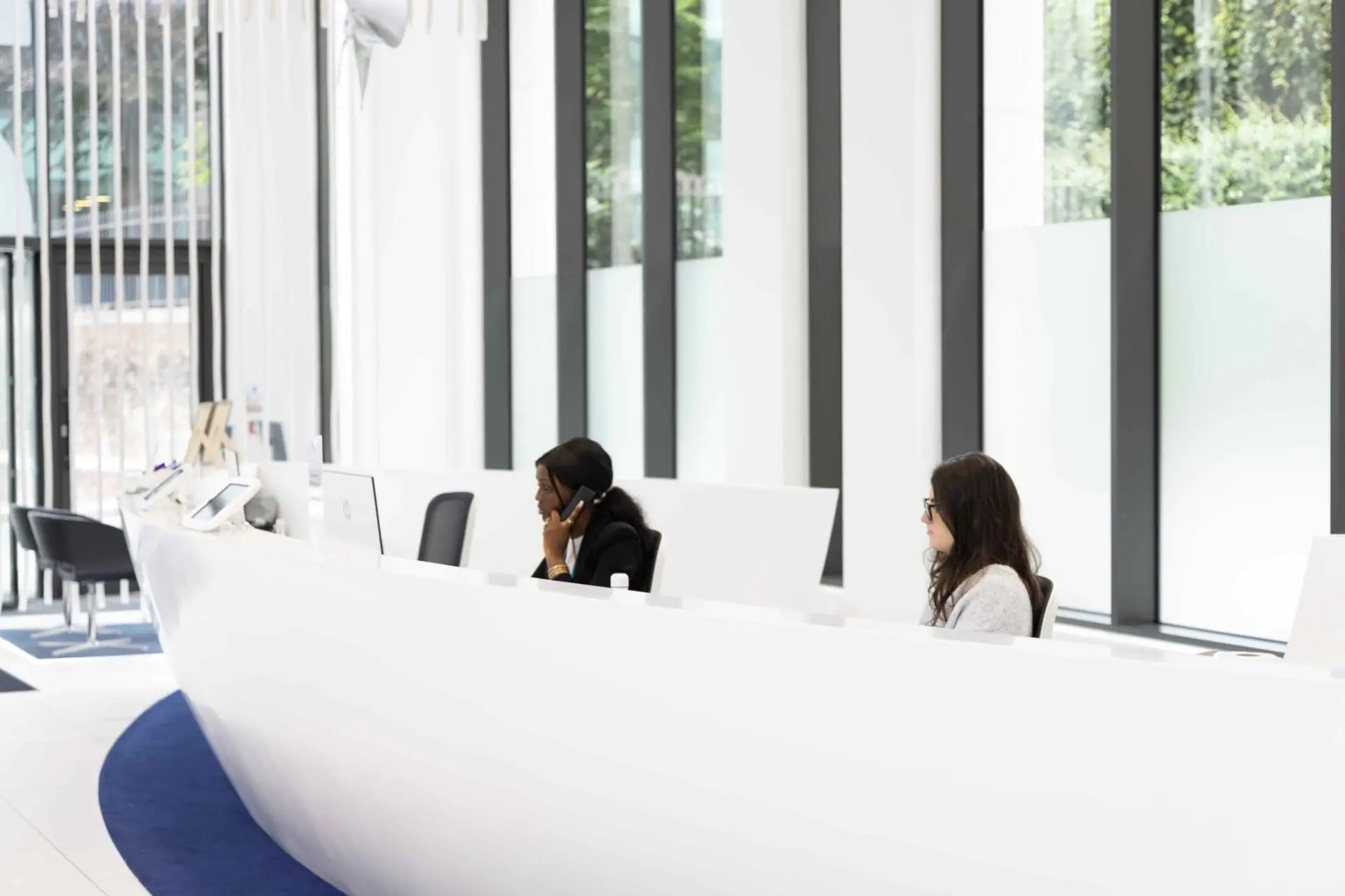 Serviced office reception staff in London EC3R, highlighting the dedicated hospitality team and unique Sun Deck themed entrance at Office Space in Town Monument, 20 St Dunstan’s Hill.
