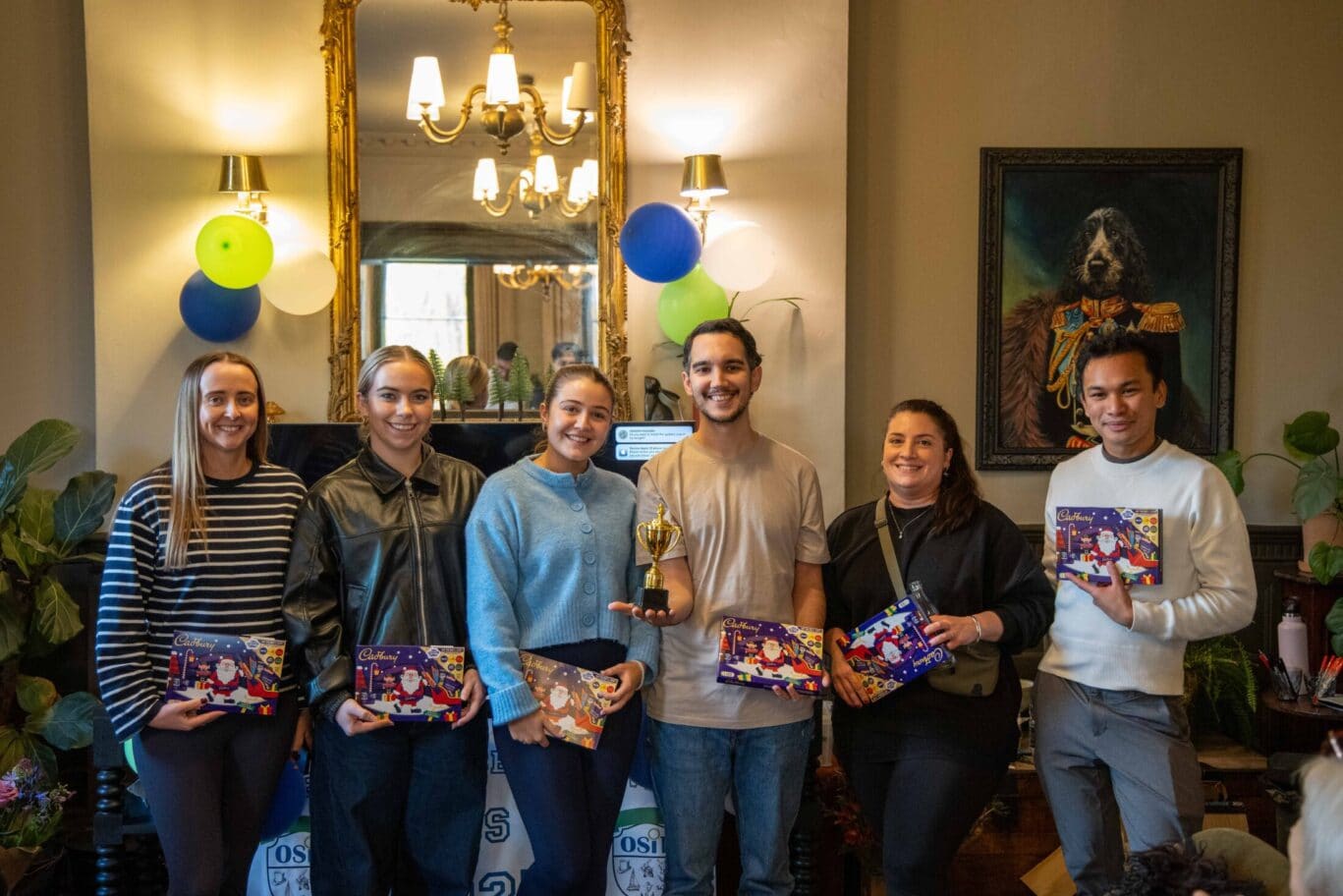 Award winning OSiT team members celebrating their victory during a team building game at the annual staff weekend away, highlighting the competitive spirit and camaraderie of the OSiTeers.