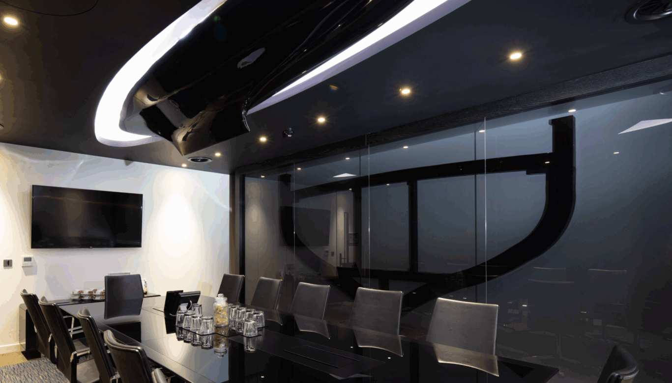 The Keel meeting room at OSiT Monument, featuring a luxury nautical-inspired interior with polished wood finishes, porthole-style windows, and sleek yacht-style boutique decor in the City of London.