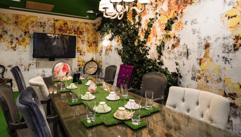 Creative meeting space for hire in Waterloo, London SE1, showcasing the Mad Hatter themed room with high-spec AV facilities, unique teapot lighting, and a vibrant atmosphere for team brainstorming.