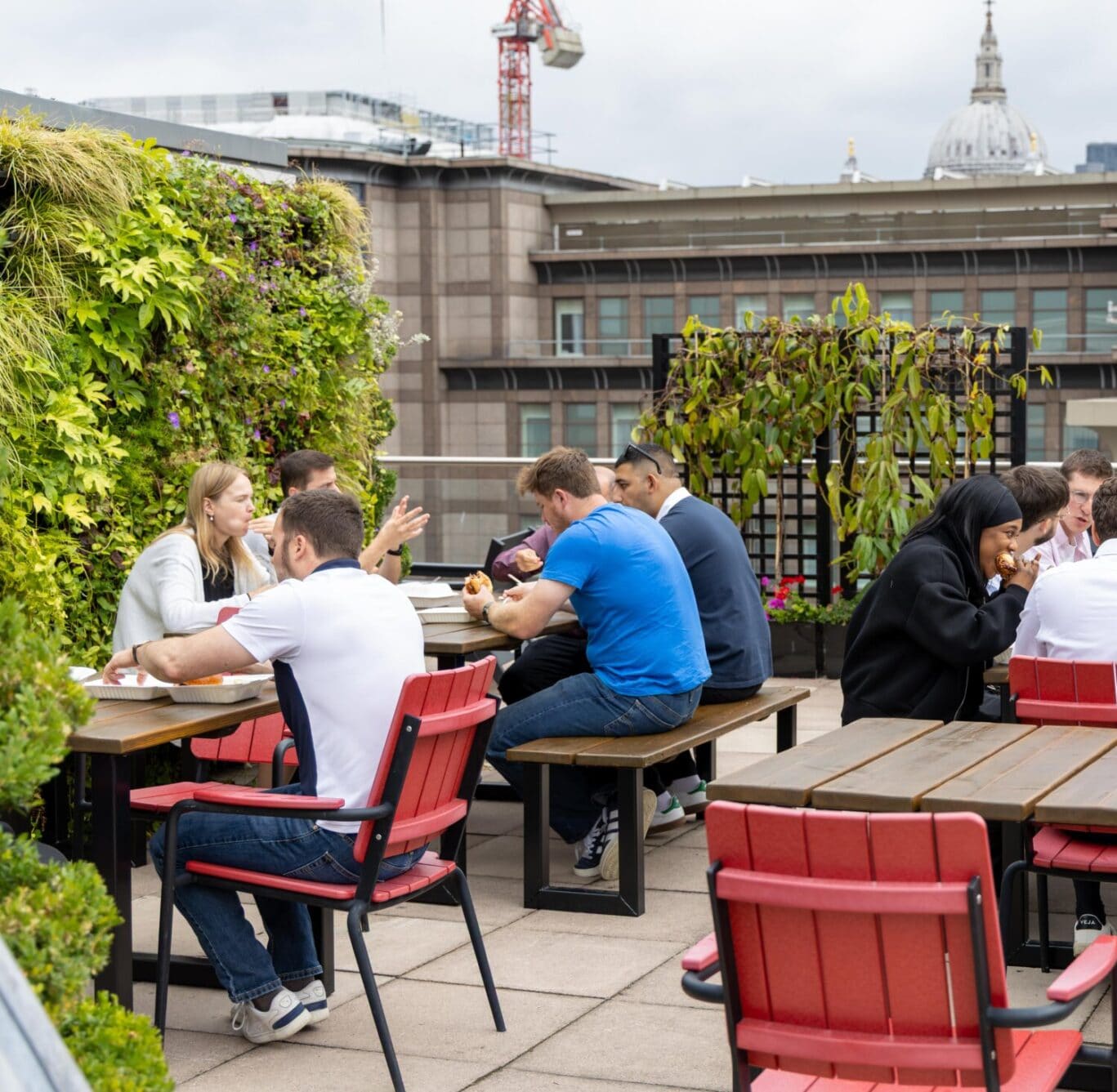 Guests enjoying the annual OSiT summer party on the Blackfriars rooftop terrace, showcasing the vibrant community spirit and 