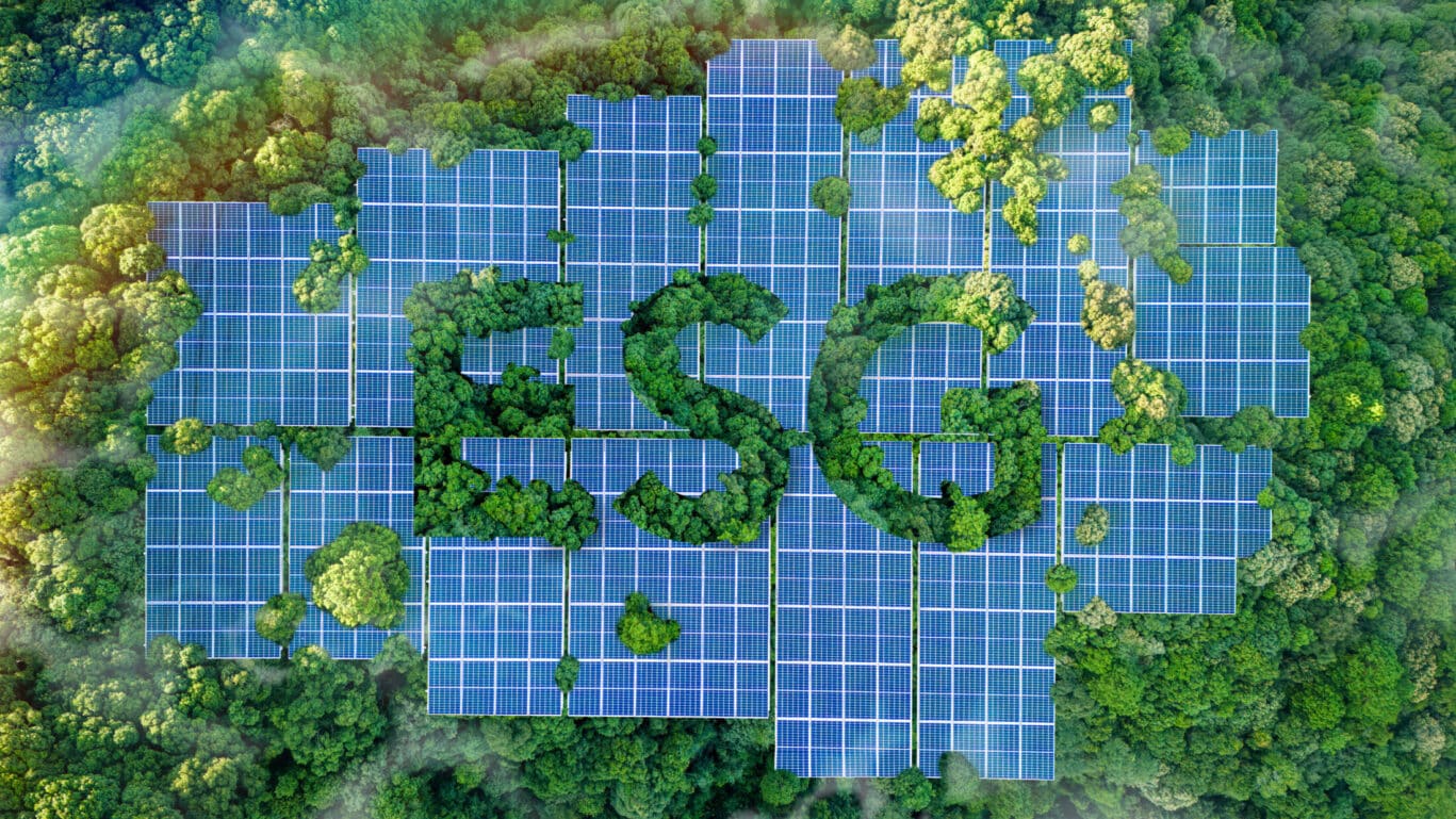 ESG concept for environmental, social, and governance sustainable business. the word ESG is on a solar panel installed in a lush forest. Sustainable organizational development. environmentally friendly energy