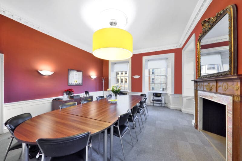 Luxury boardroom hire in Edinburgh, highlighting the themed Edinburgh meeting room at St Andrew Square for executive sessions, legal briefings, and high-level corporate presentations.