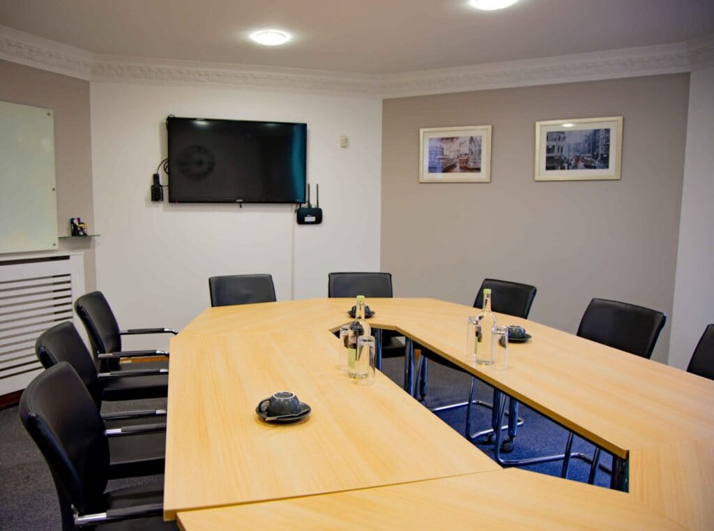 Luxury meeting room hire in Cardiff City Centre, highlighting the professional boardroom facilities at OSiT on Greyfriars Road near Cardiff Castle for executive briefings and creative workshops.