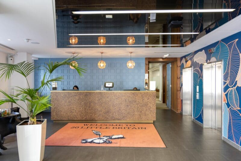 A prestigious manned reception desk at Office Space in Town St Paul's, showcasing the high-end boutique entrance and professional concierge services for serviced office clients.
